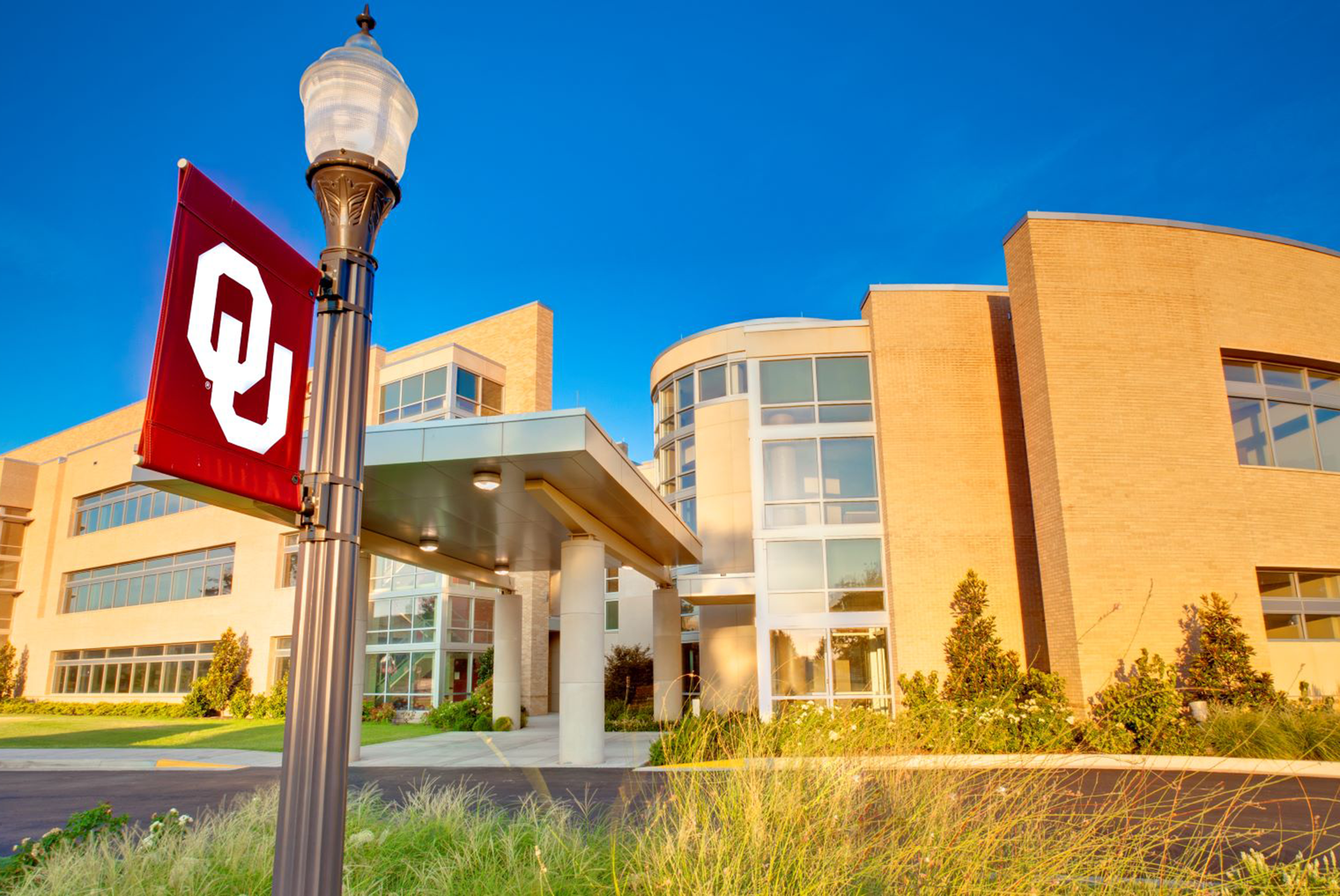 The college of community medicine Tulsa building and ou flag stand.